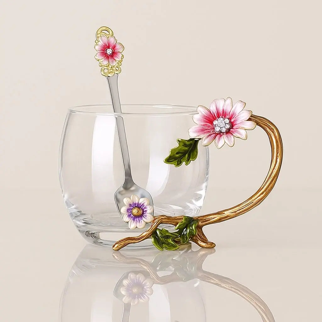 Transparent glass teacup featuring delicate floral enamel design and gold-tone handle