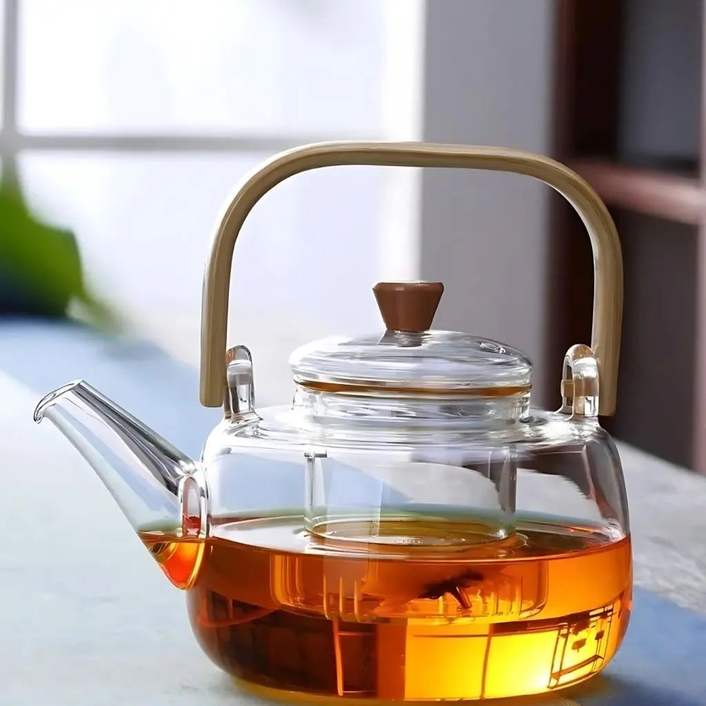 Premium glass teapot featuring bamboo handle and clear borosilicate construction for stovetop tea brewing