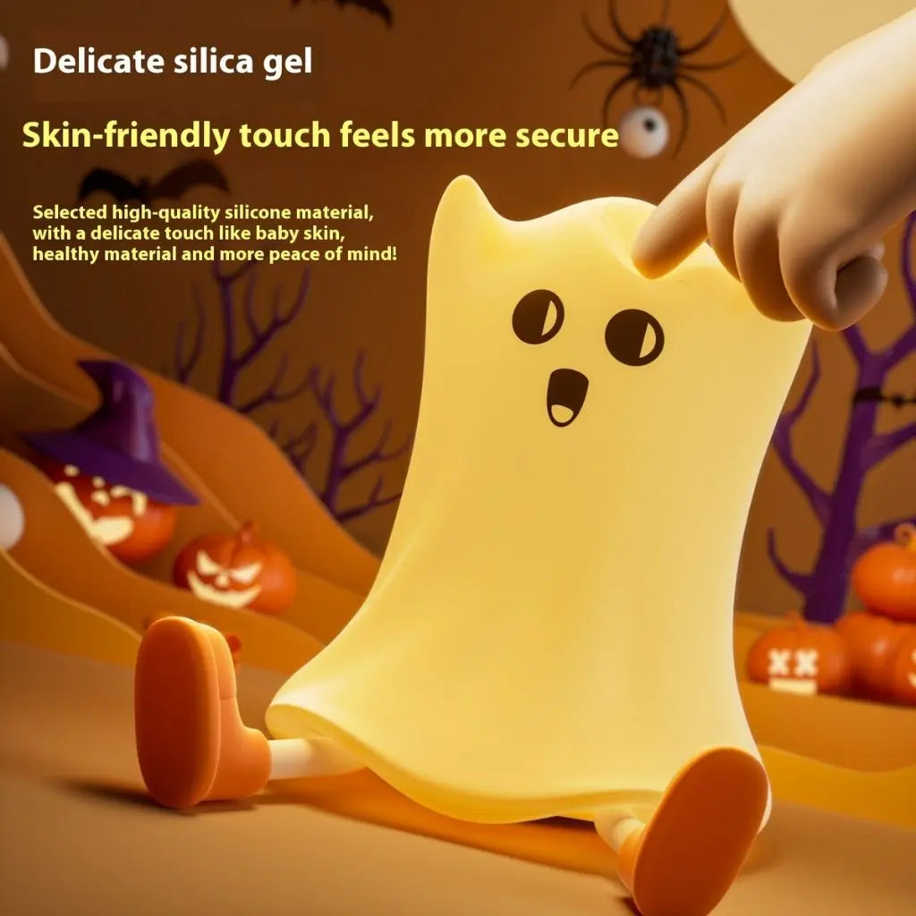 Ghost-shaped toy with a Halloween-themed background featuring pumpkins and a spider.