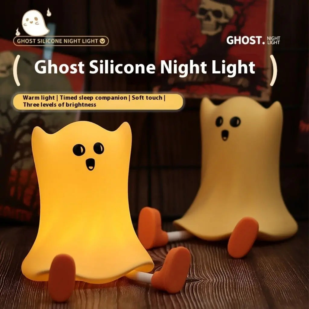 Ghost-shaped silicone night light with text highlighting features on a wooden surface.