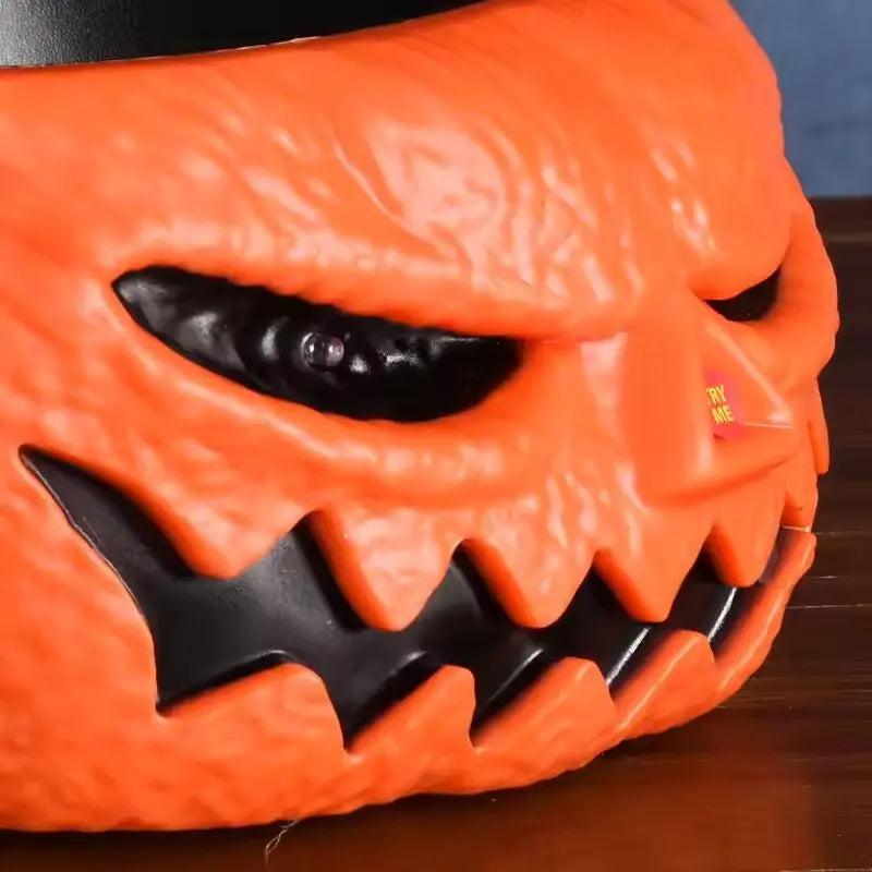 Orange pumpkin-shaped basket with black facial features on a wooden surface