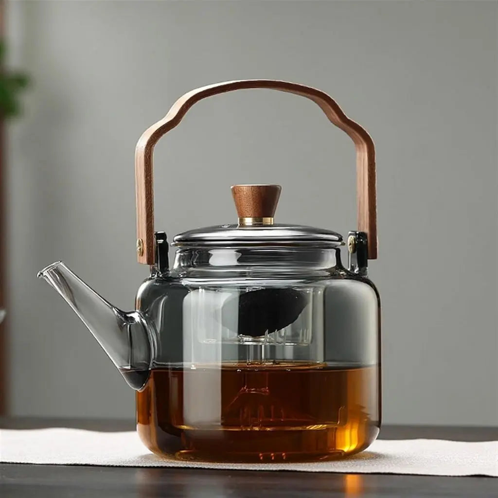 Heat-resistant glass teapot with wooden handle ideal for serving multiple cups