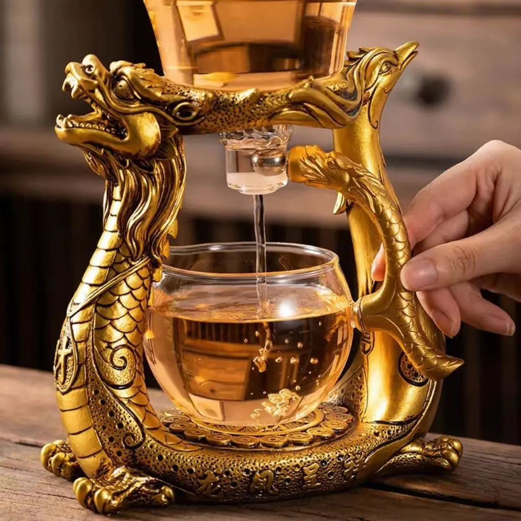 Golden dragon phoenix teaware with transparent glass brewing chamber for elegant tea steeping and presentation
