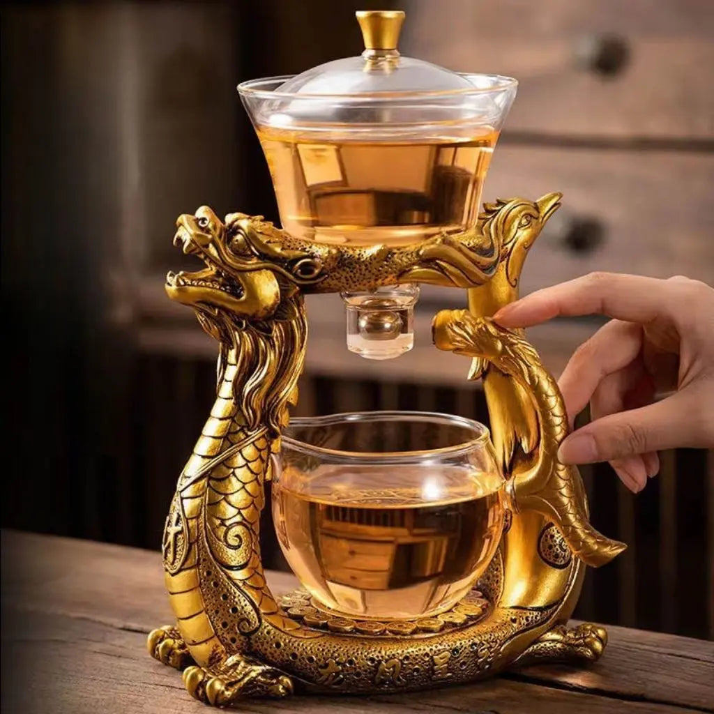 Artisan glass teapot with decorative dragon phoenix base combining functionality with asian cultural aesthetics