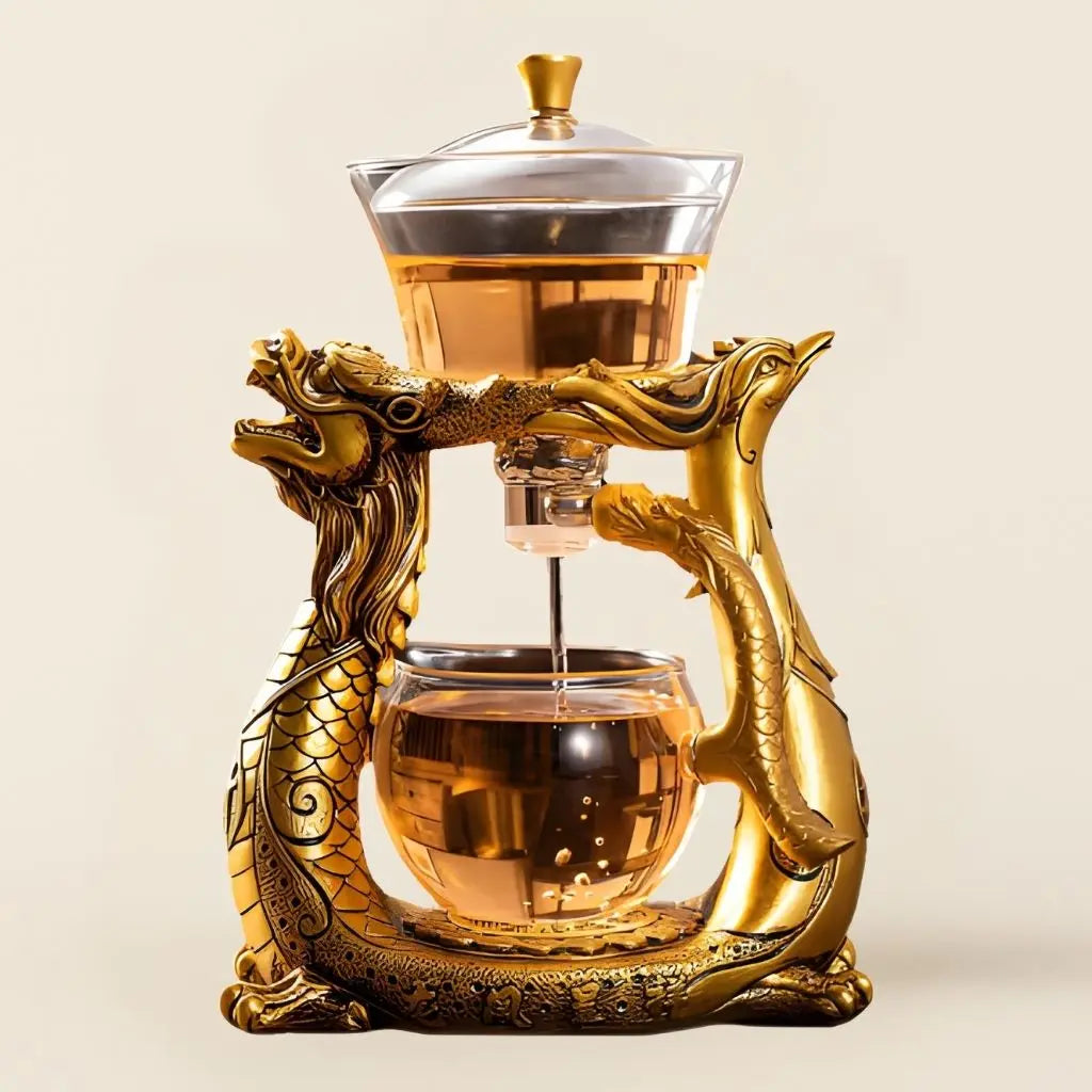 Heat resistant glass tea maker with golden dragon phoenix base for ceremonial tea brewing and cultural elegance