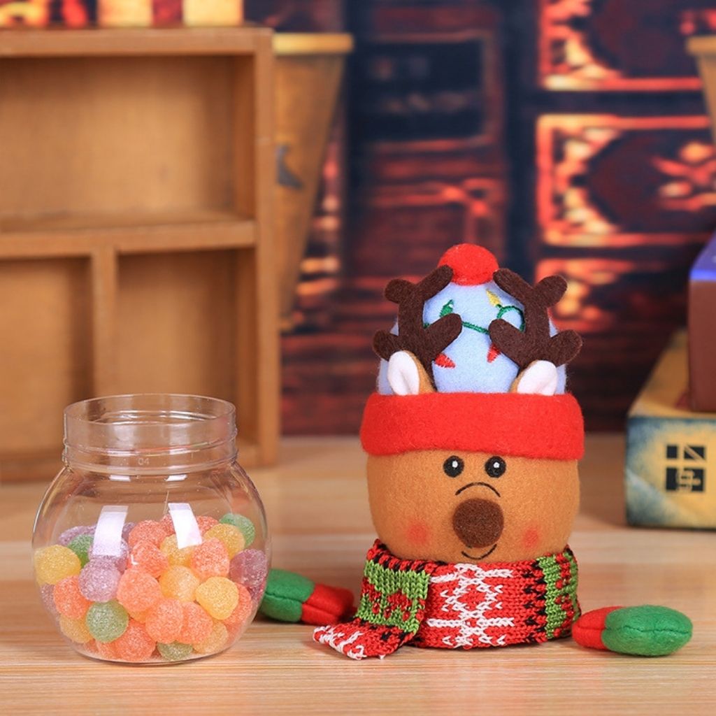 Festive treat holder with stitched plush topper holding assorted candies and chocolates