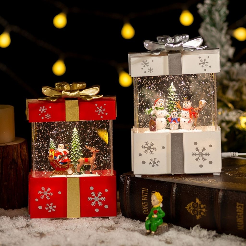 Christmas gift box light with red ribbon and illuminated snow scene interior