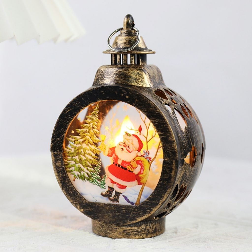 Battery powered Christmas lantern with rounded frame and interior holiday scene