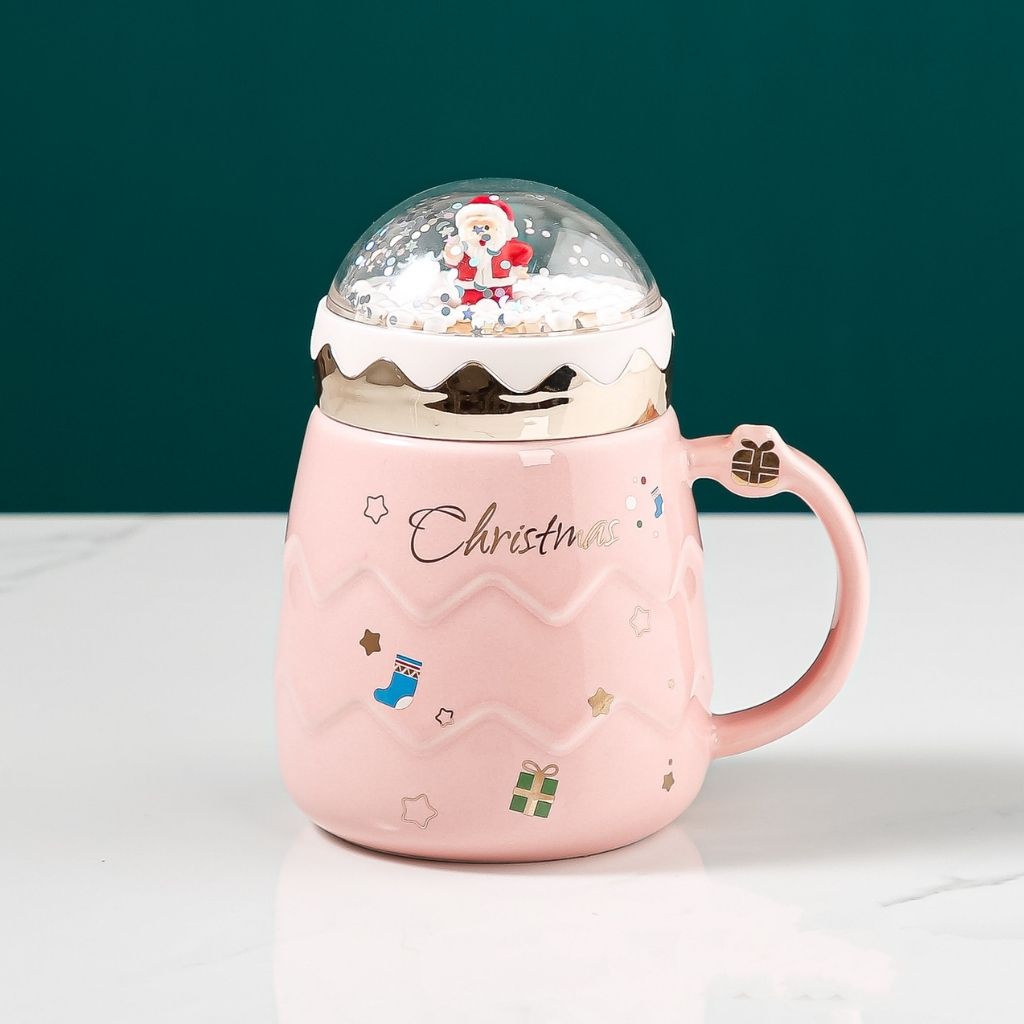 Festive ceramic mug with miniature snow globe lid and glossy glazed finish