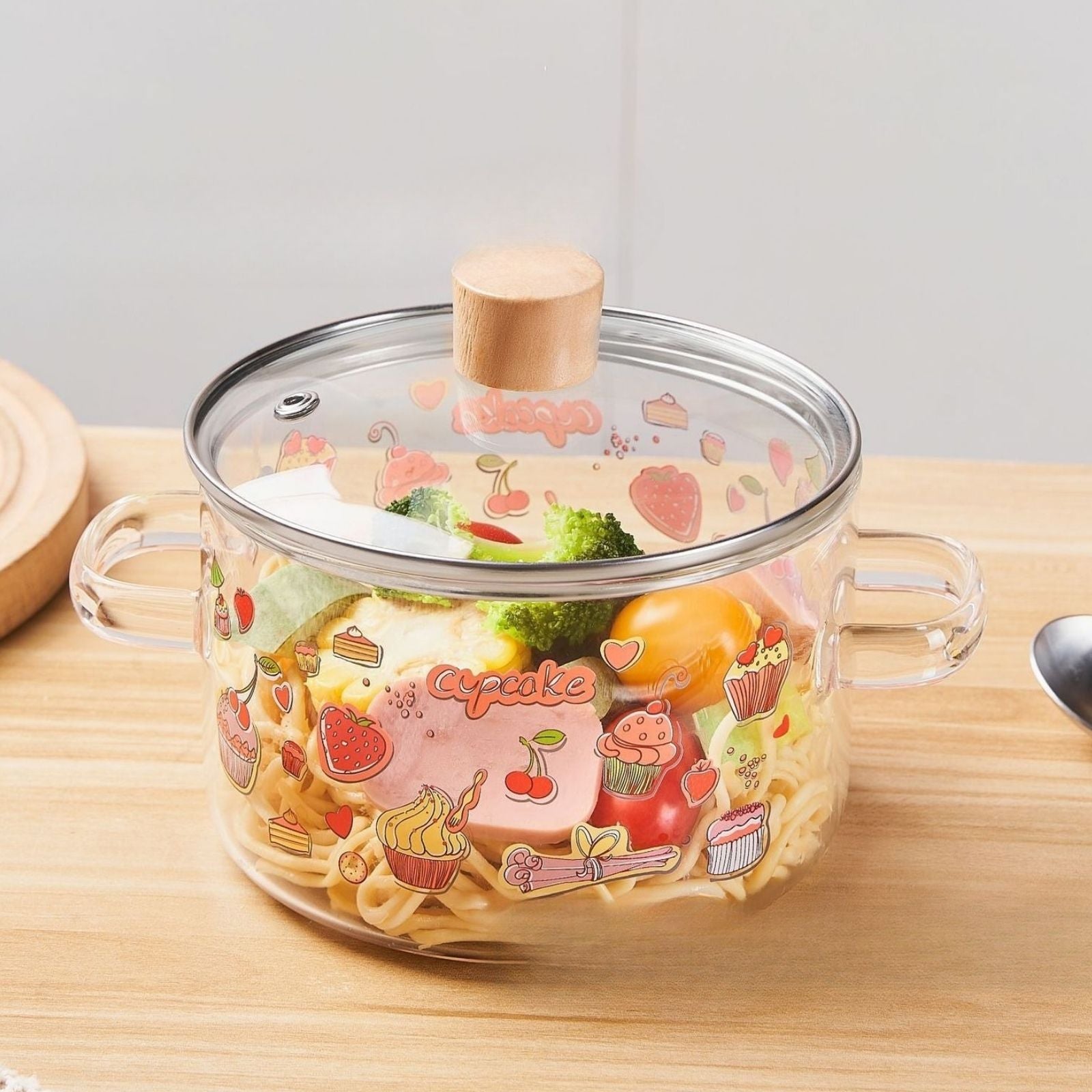 Heat resistant glass pot featuring cupcake themed design with clear body