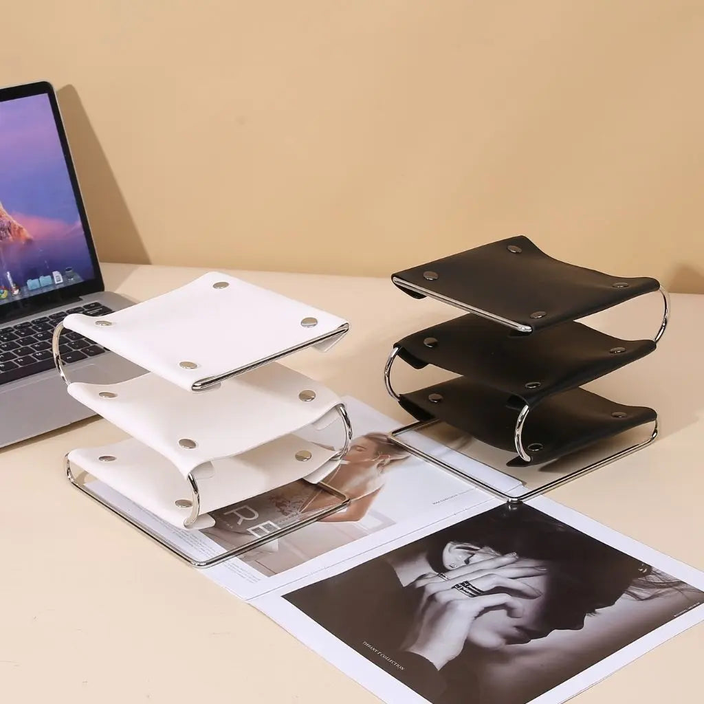 Sleek leather desktop organizer with metal frame holds phones keys and office accessories