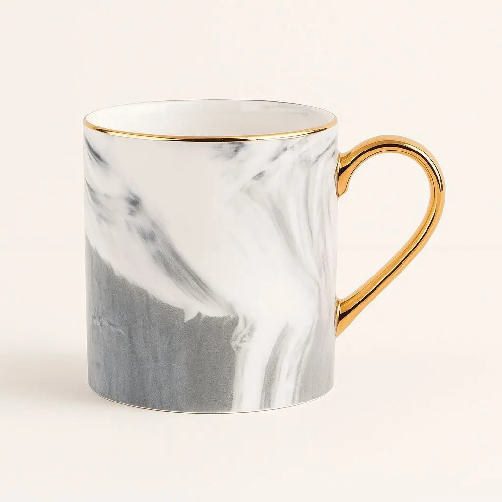 Marble-patterned mug with gold handle on a white background