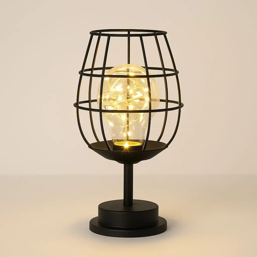 Black cage-style table lamp with a glowing light bulb on a beige background