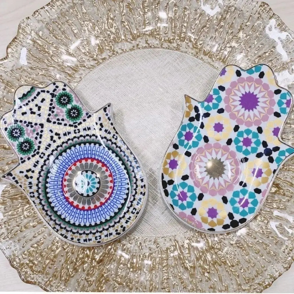 Hamsa ceramic tray with vibrant evil eye and triangle emblem design serving as decorative jewelry storage