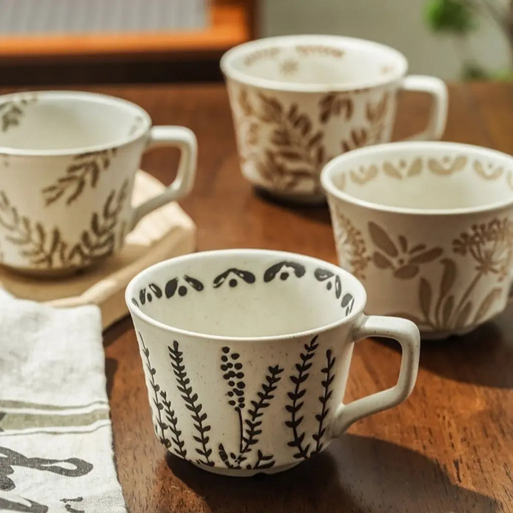 Nordic ceramic mug showcasing botanical pattern, minimalist white porcelain coffee cup design