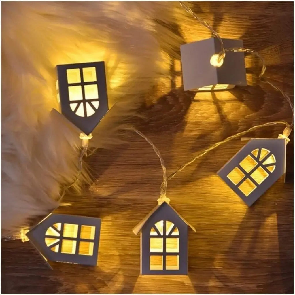 Artisan wooden house string lights with intricate cut-out details and warm LED glow for home decor