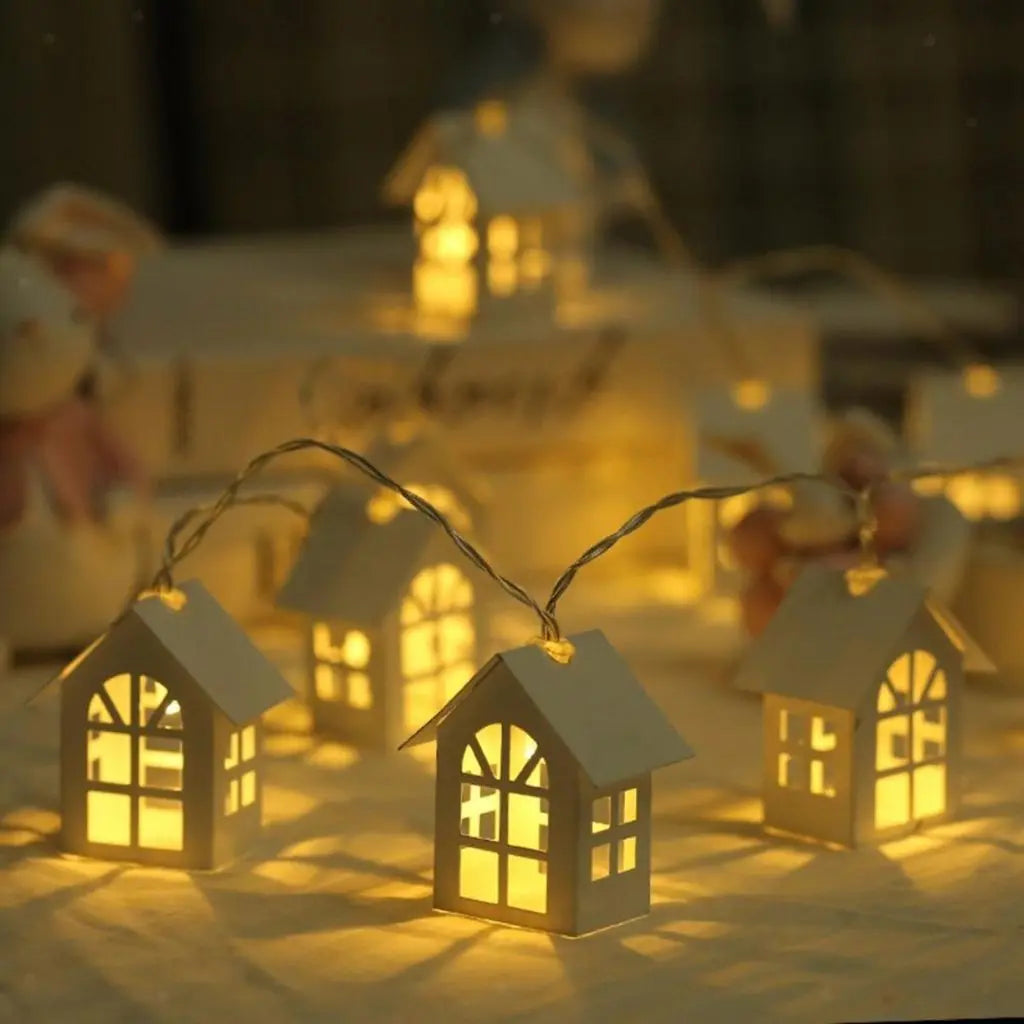 Artisan wooden house string lights with intricate cut-out details and warm LED glow for home decor