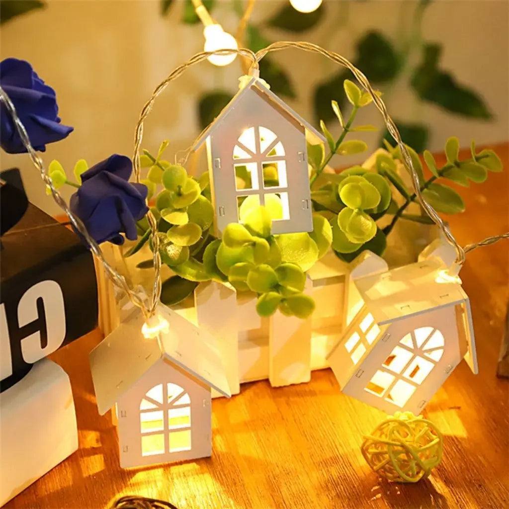 Artisan wooden house string lights with intricate cut-out details and warm LED glow for home decor
