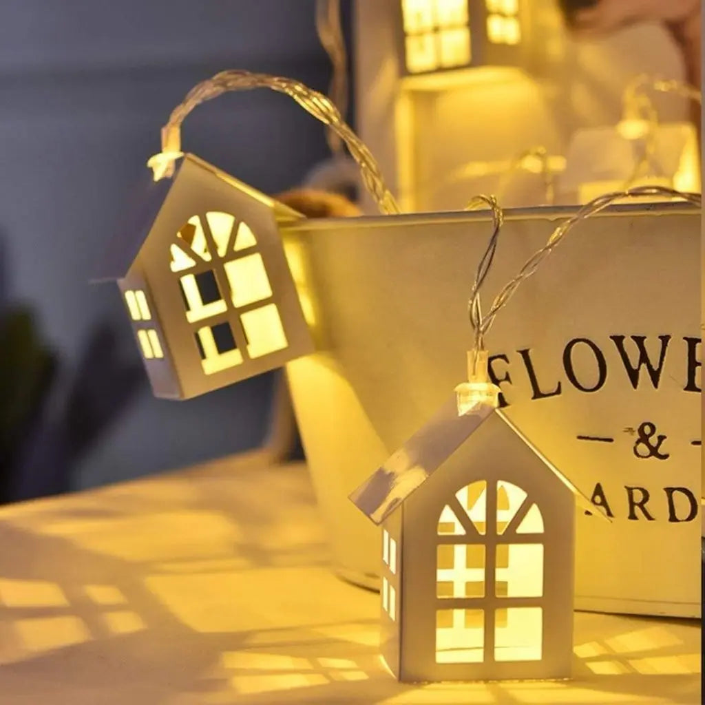 Artisan wooden house string lights with intricate cut-out details and warm LED glow for home decor
