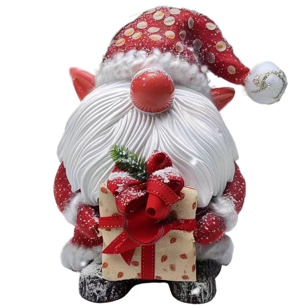 Festive resin gnome with bright red pointed hat white fluffy beard and present front view