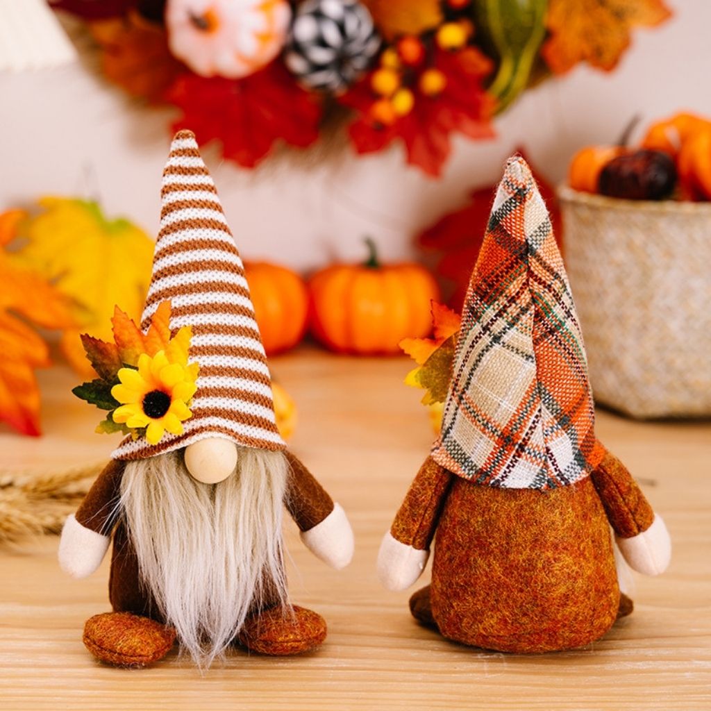 Harvest gnome ornaments with sunflower and maple leaf details for Thanksgiving tabletop decor