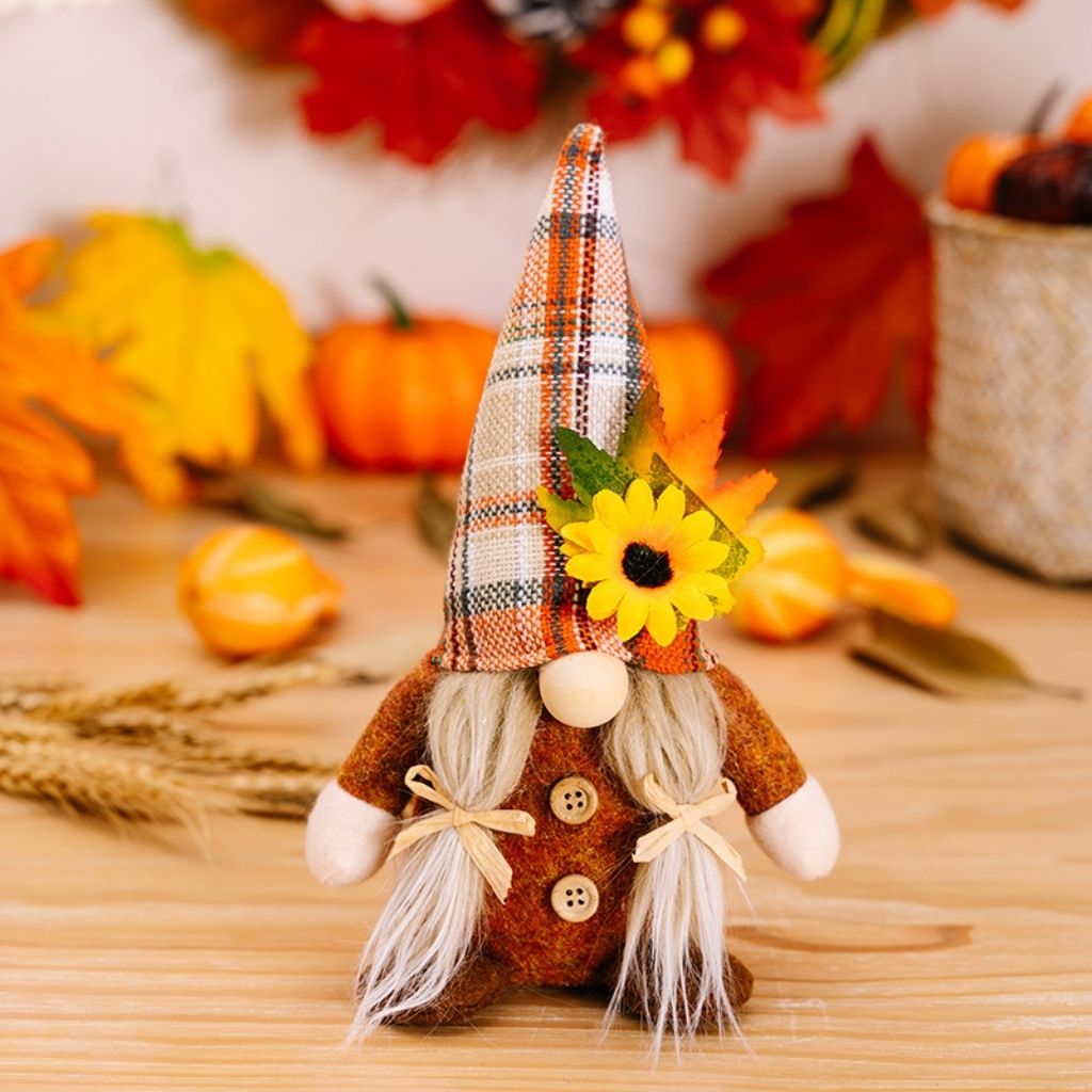 Autumn gnome dolls with maple leaf accents and patterned hats for seasonal display