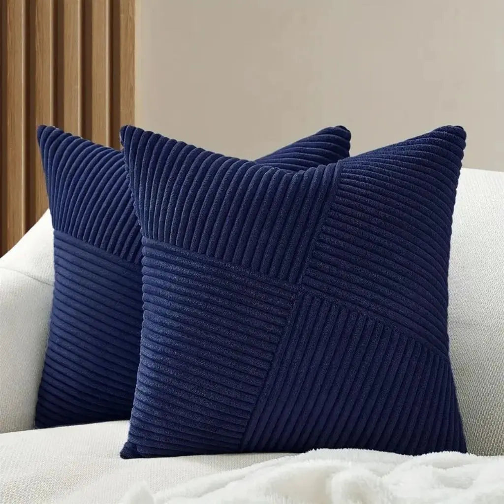 Corduroy throw pillow with ribbed patchwork texture adding sophisticated accent to sofa and bed styling