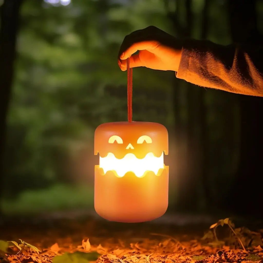 Hand holding a glowing Halloween-themed lantern in a forest setting