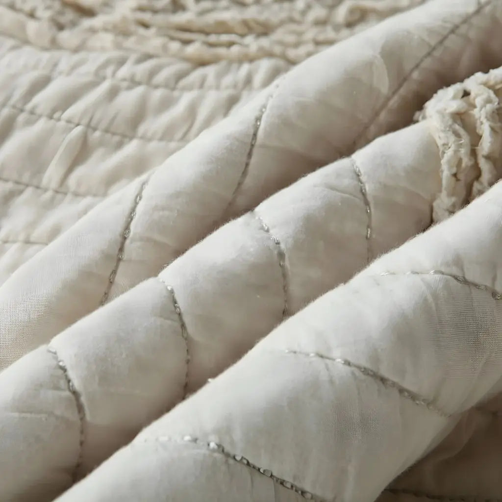 Quilted cotton bedspread showcasing embroidered circle motifs with refined textile craftsmanship