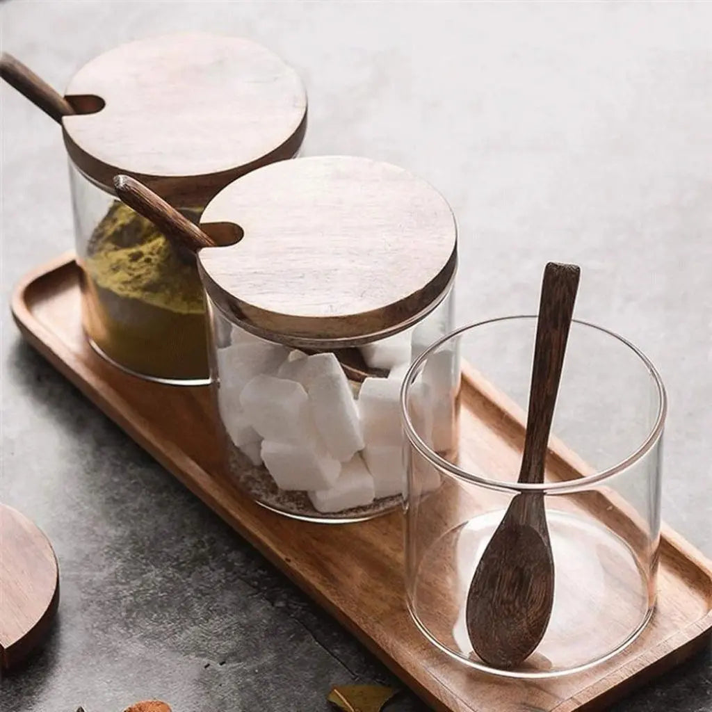 Glass spice jars with wooden lids for airtight kitchen storage and spice organization.