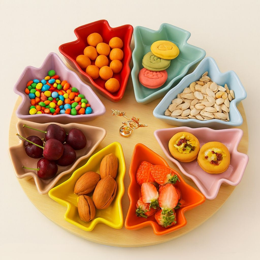 Five porcelain tree shaped serving dishes with gradient rainbow finish arranged on white ceramic base