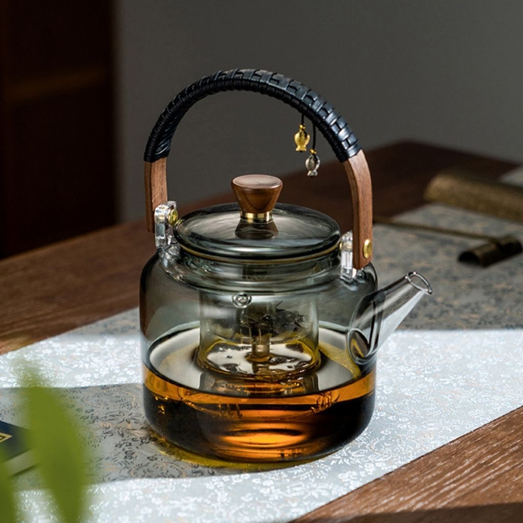 Glass teapot with two matching tasting cups for tea service
