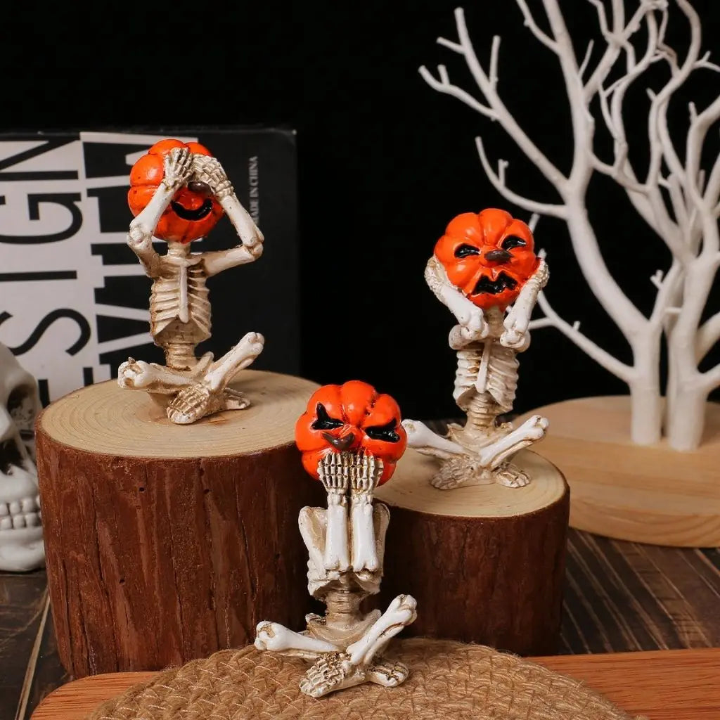 Halloween-themed skeleton figurines with orange pumpkin faces on wooden stumps.