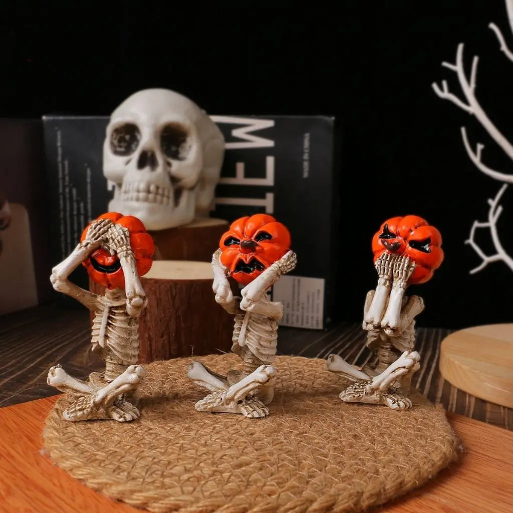Pumpkin skull trio figurines featuring skeleton bodies with carved jack-o-lantern heads for halloween decorations