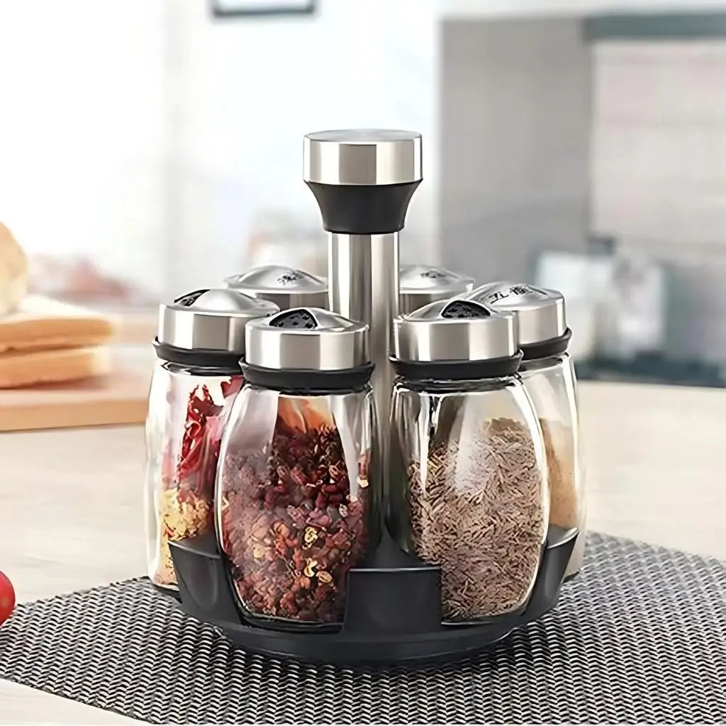 Set of glass spice jars with metal lids on a kitchen counter