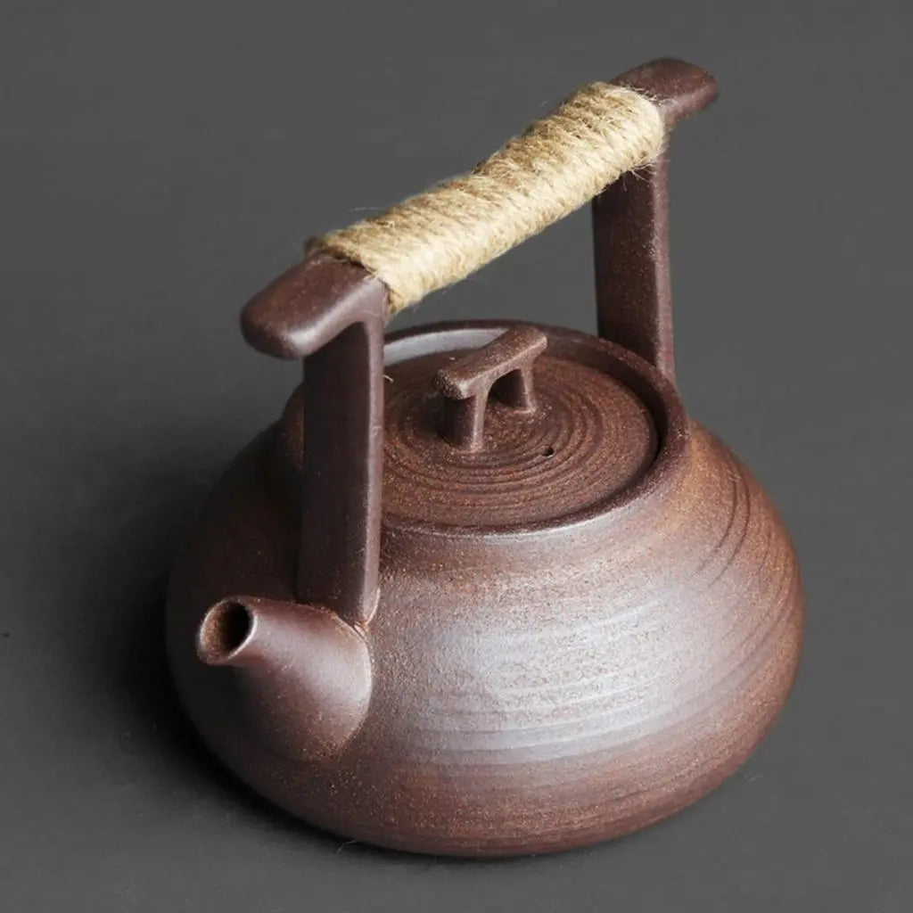 Rope-wrapped ceramic teapot handle with natural stoneware texture for secure heat-resistant grip