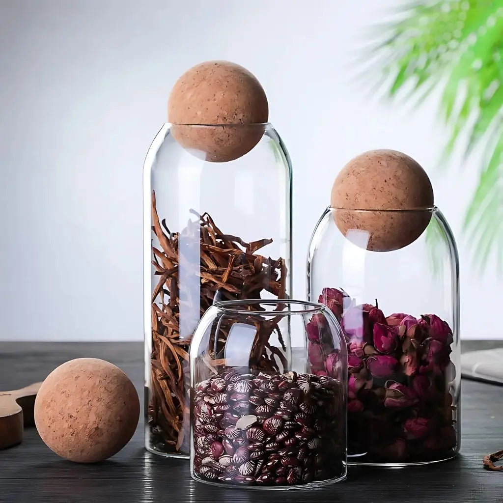 Clear glass storage jars with airtight cork seals keeping coffee beans and tea leaves fresh