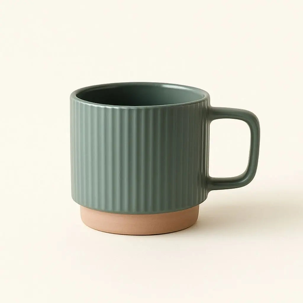 Green ceramic mug with ribbed texture on a beige background