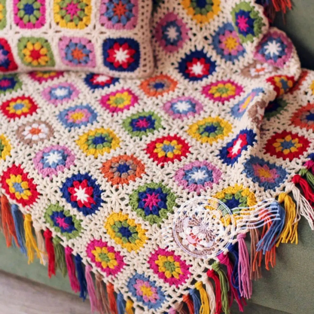 Artisan crochet throw with handcrafted floral patterns and boho style tassel accents