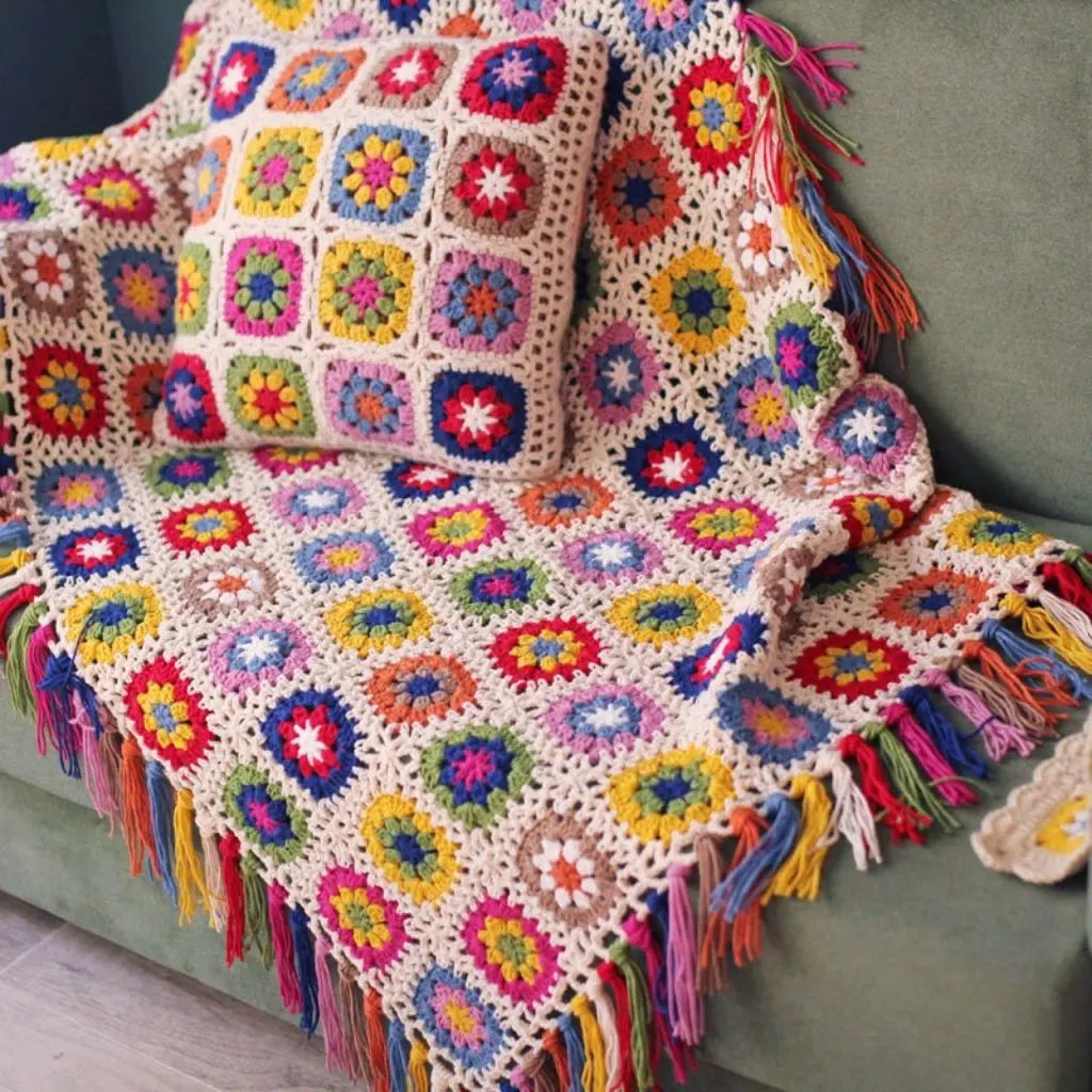 Vintage crochet blanket with handmade tassel edges and colorful floral yarn patterns