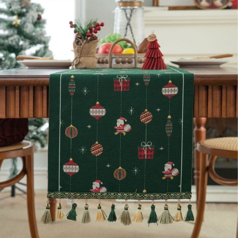 Green jacquard table runner with gift box pattern on white surface