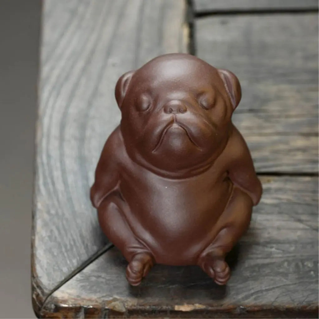 Sleeping dog tea pet in peaceful pose crafted from premium purple sand clay, perfect tea companion