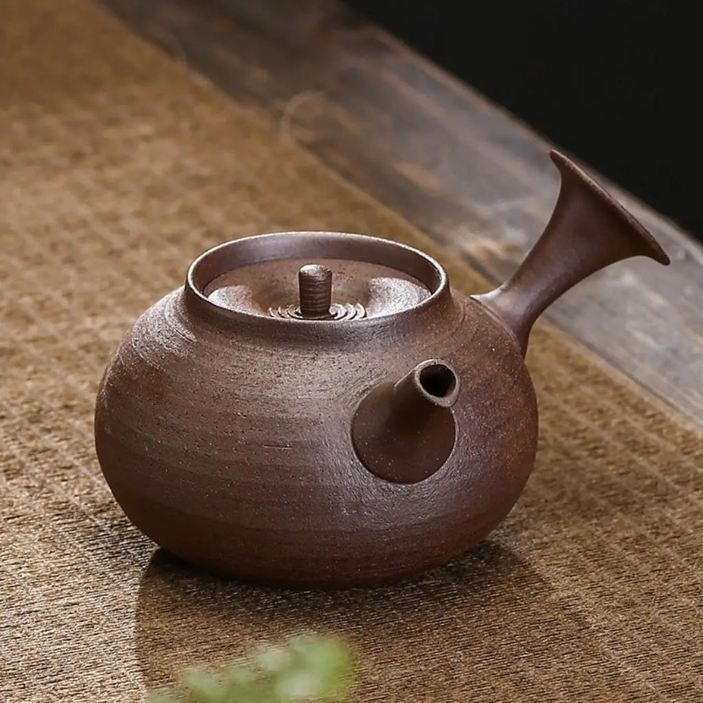 Handcrafted pottery teapot with rounded body design, featuring balanced spout for smooth tea pouring