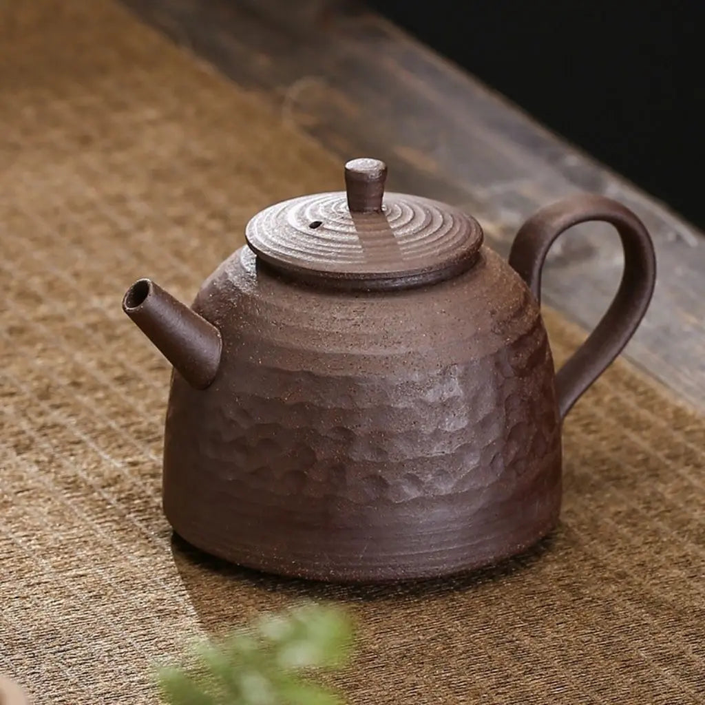 Ceramic teapot showcasing traditional pottery craftsmanship with ancient-style surface texture finish