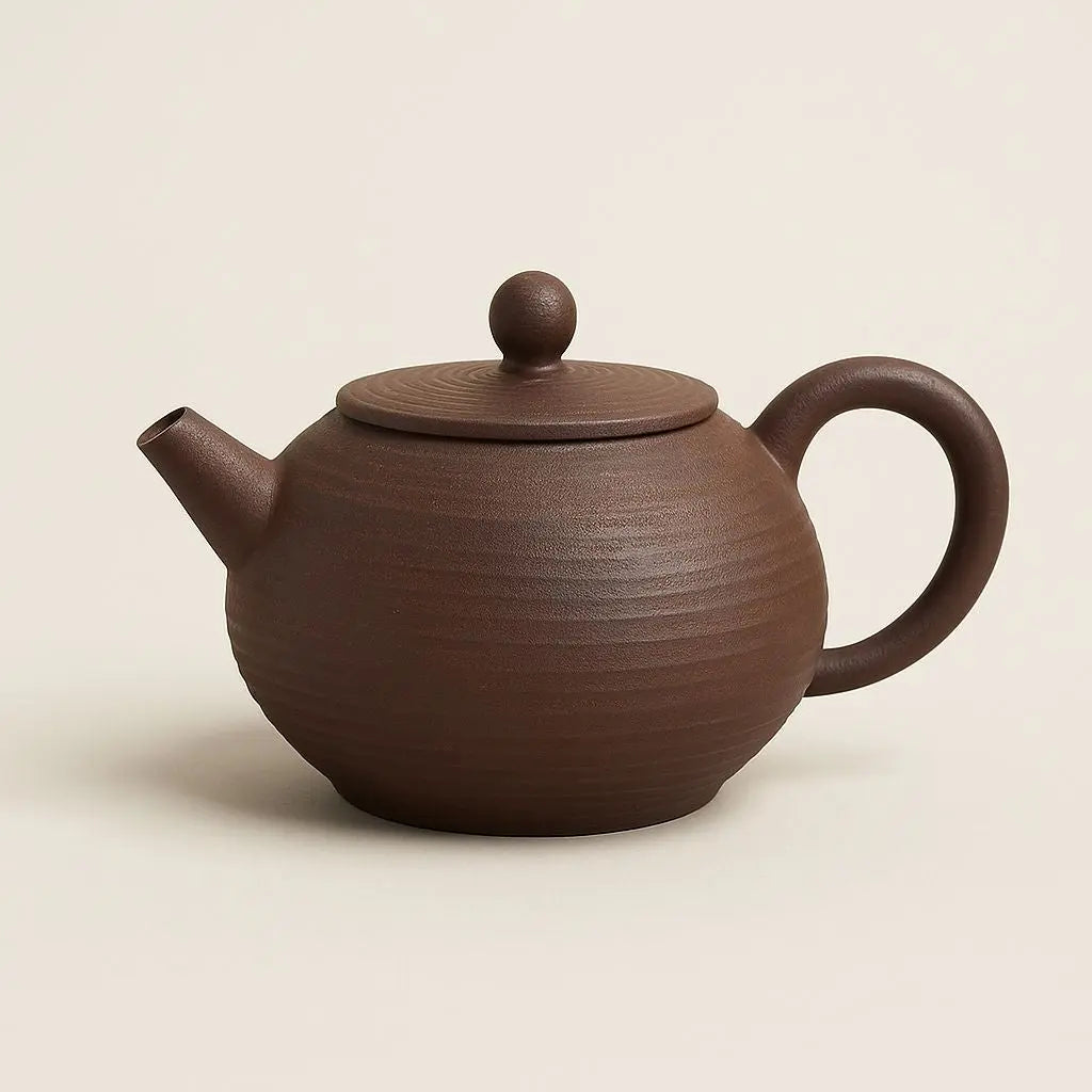 Handmade ceramic teapot with ancient pottery finish, perfect for traditional tea brewing and ceremonial sessions