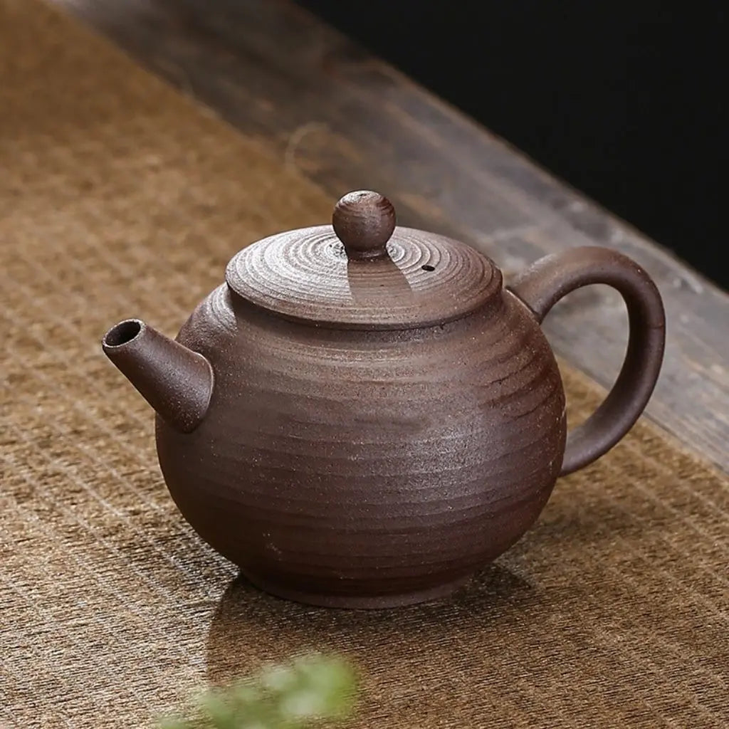 Ceramic tea pot featuring smooth pottery surface and ergonomic handle for comfortable tea brewing experience