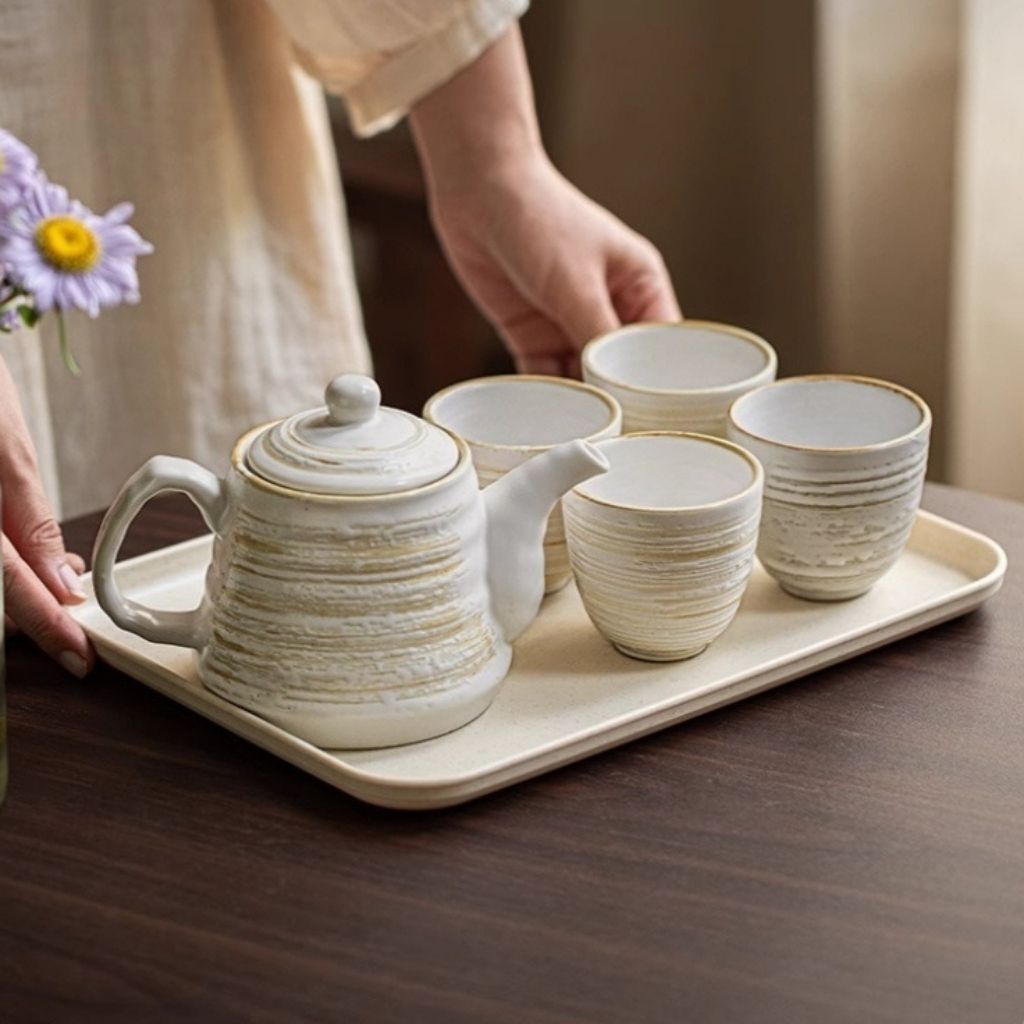 Handcrafted ceramic tea set with visible textured glaze and artisan matte finish detail