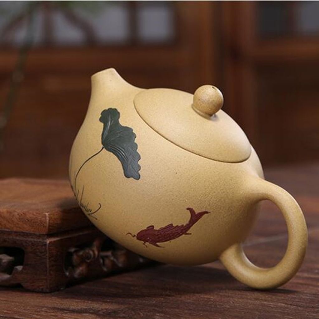 Top view of purple sand clay teapot showing fitted lid with rounded knob and calligraphy