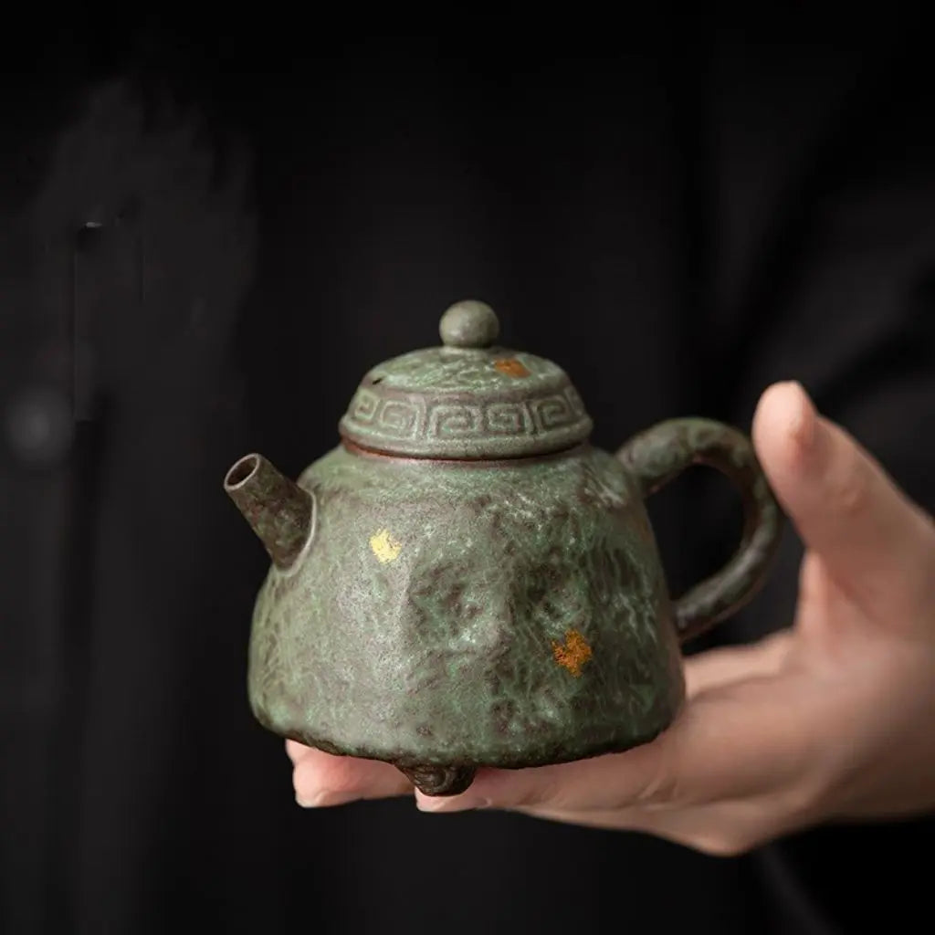 Handcrafted stoneware teapot with bronze moss glaze finish and golden accents for authentic tea brewing