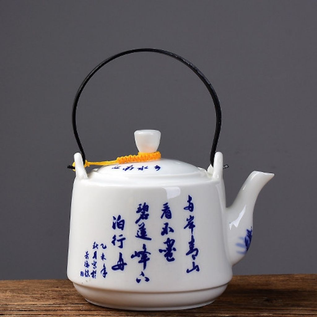 White porcelain tea pot with side handle and decorative mountain painting